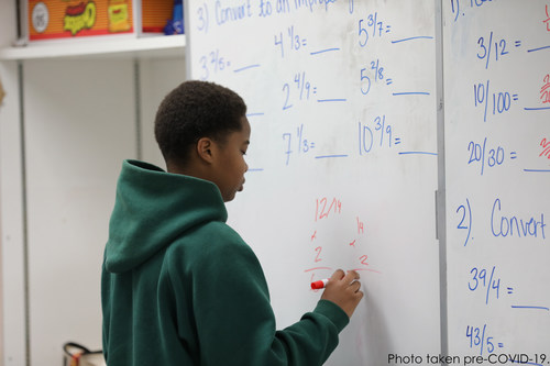 Boy Solving Math Problem